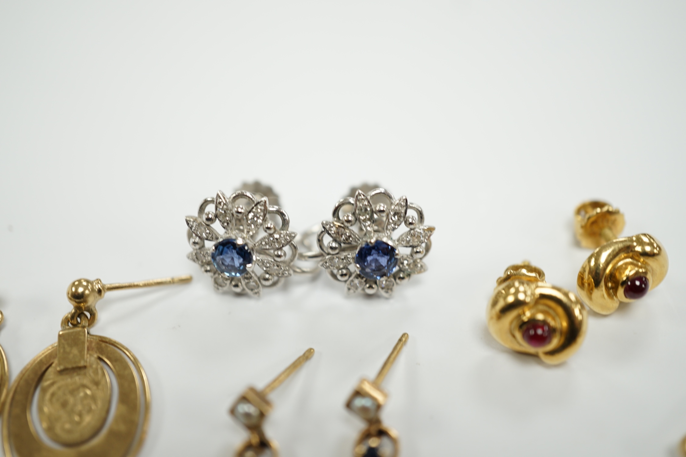 Three pairs of assorted 9ct gold earrings including two gem set, a pair of white metal (stamped 18) and gem set ear clips and a pair of 18k and cabochon ruby ear studs.